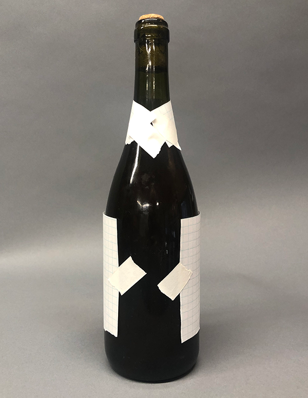 Photo of paper taped to bottle: Back