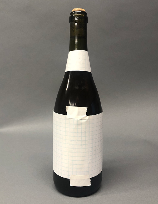 Photo of paper taped to bottle: Front
